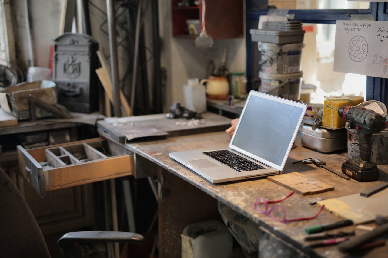 Crafting Captivating Headlines: Your awesome post title goes here From above of modern laptop laying at table among different tools and equipment in workshop